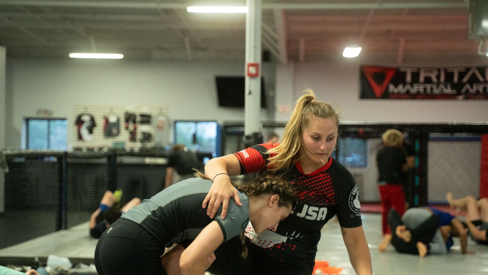 Two students working a ground position against each other during a live round.