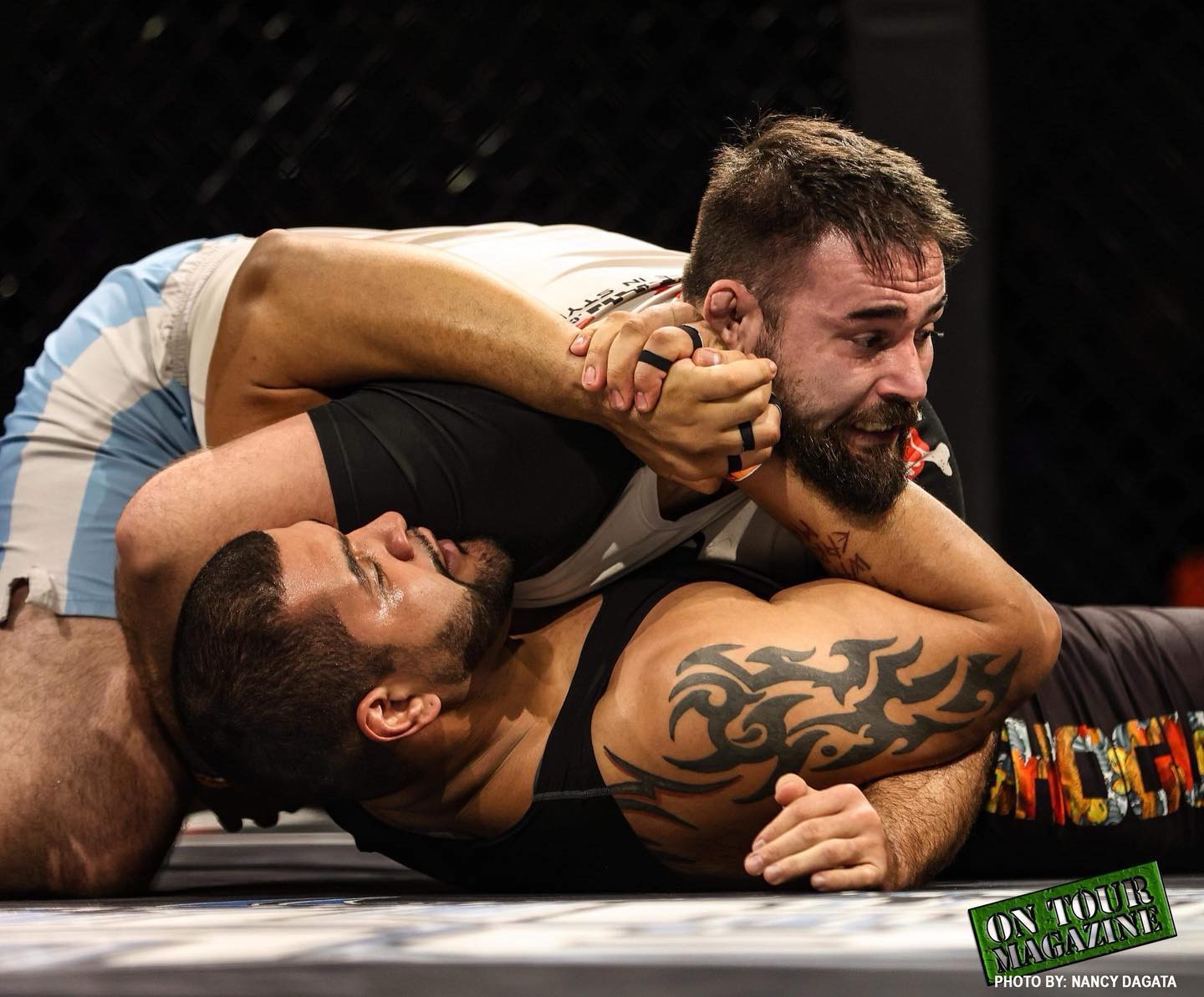 A TRITAC grappler controlling an opponent from top position in competition