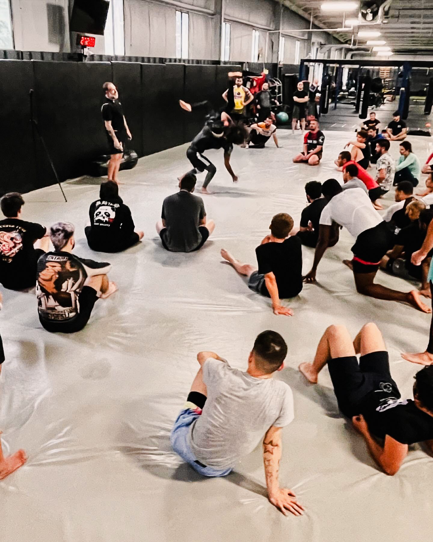 Matt teaching a self-defense scenario to a group of students gathered around